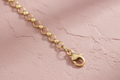 9ct Yellow Gold 3.5mm Round Belcher Chain on dusty rose textured background