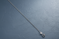 9ct White Gold 1.1mm Classic Curb Chain on slate blue textured background