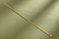 9ct Yellow Gold 3mm Flat Anchor Chain on olive green textured background