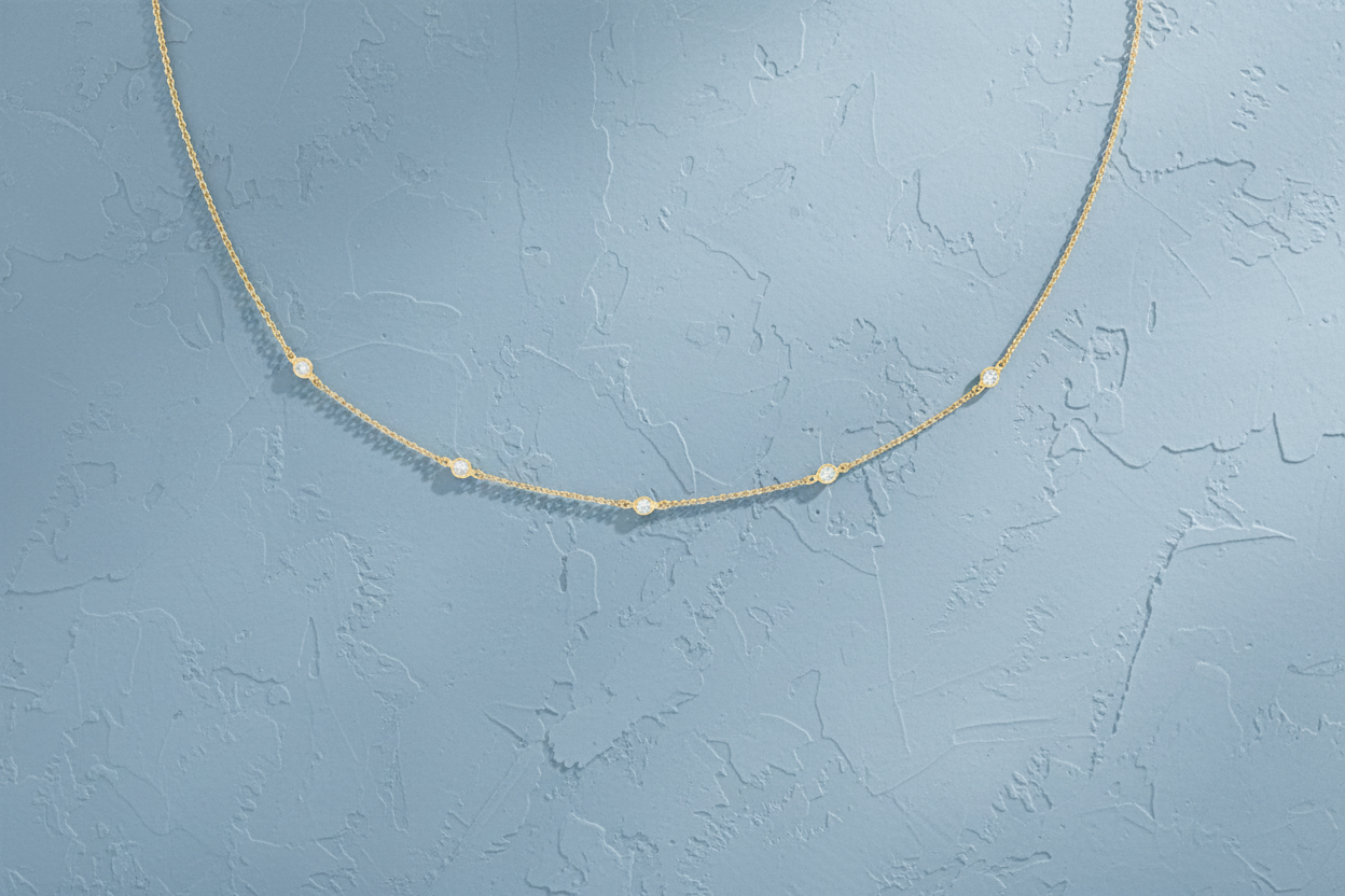 9ct Yellow Gold CZ By The Yard Bracelet & Necklace Set on dusty blue textured background