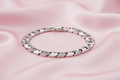Silver bracelet with clear stones on a white background
