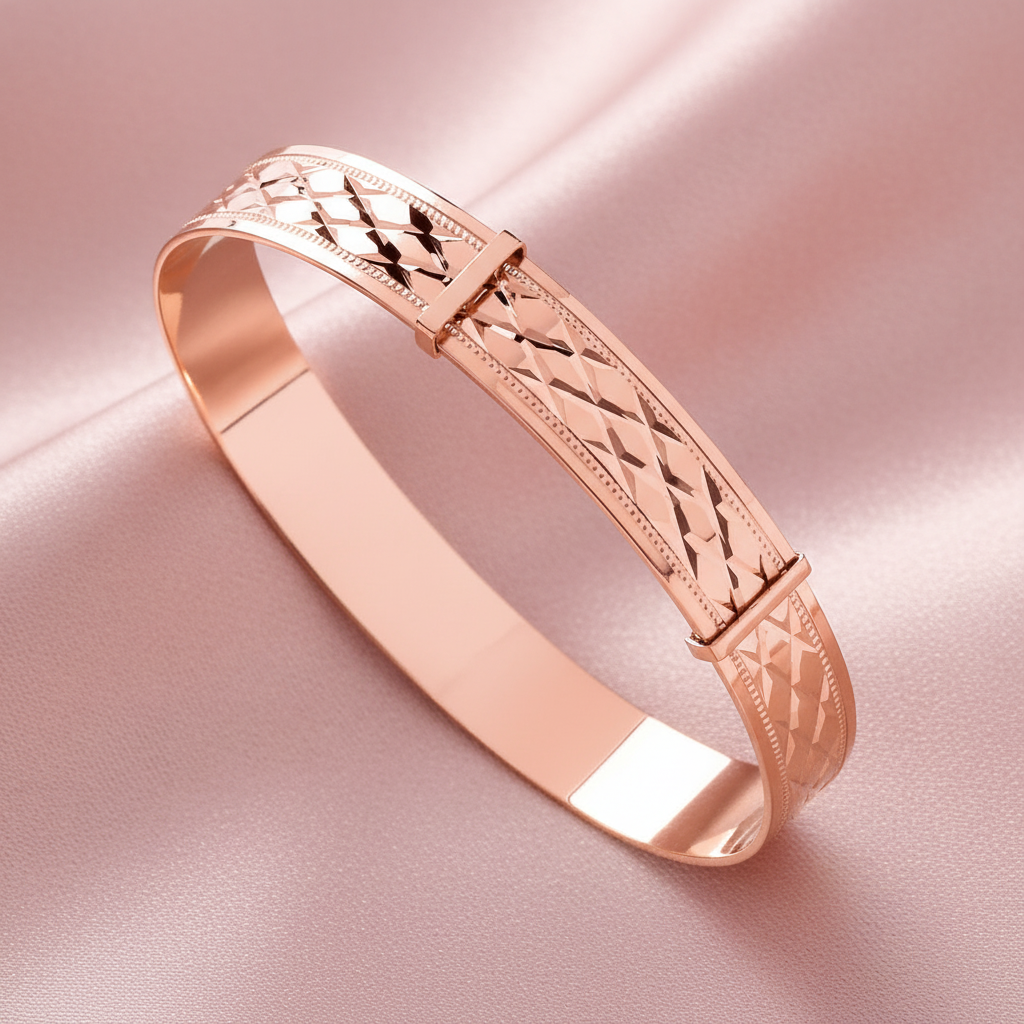 Rose gold bracelet with intricate design on a pink background