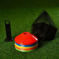 Colorful training markers with a black carrying bag on a green grass background