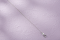 9ct White Gold 0.8mm Diamond Cut Trace Chain on lavender textured background