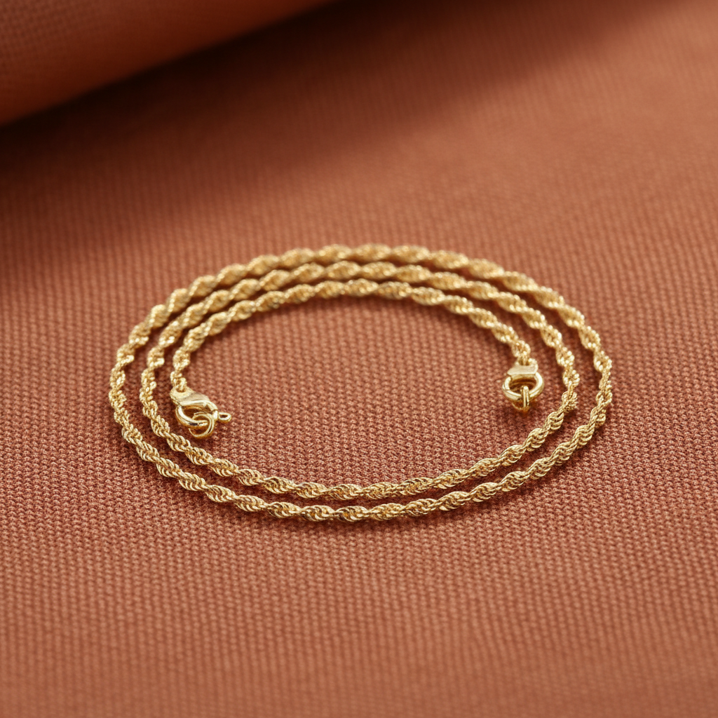 9ct Yellow Gold Singapore Anklet on warm terracotta textured background