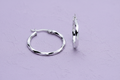 9ct White Gold 22mm Faceted Hoop Earrings on lavender textured background