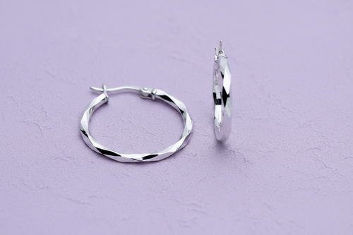 9ct White Gold 22mm Faceted Hoop Earrings on lavender textured background