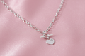 Silver T-bar CZ necklet on bubblegum pink silk background