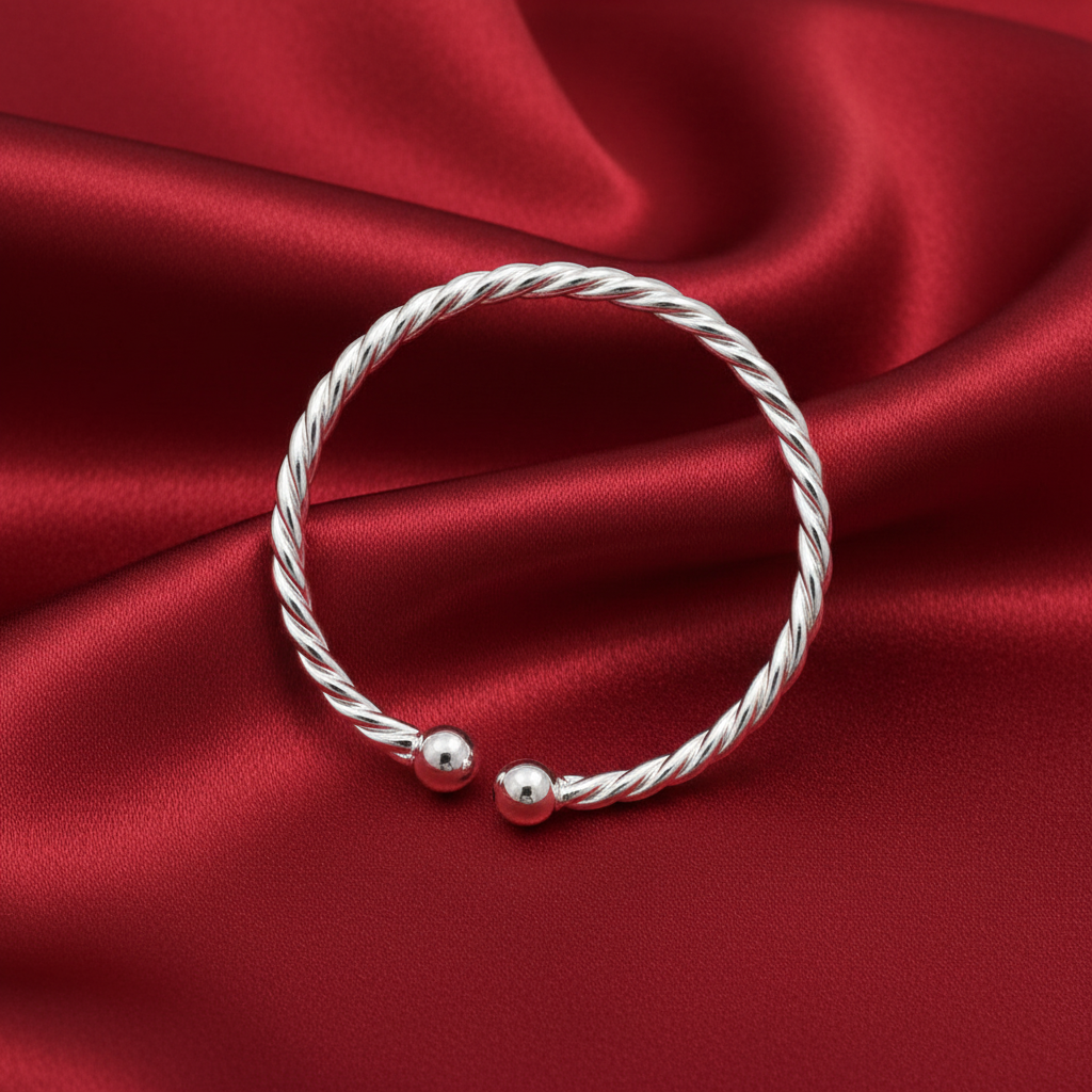 Silver Ladies Twisted Torc Bangle on soft red silk background