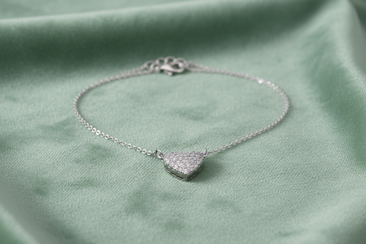 Silver CZ pavé heart pendant on sage green velvet background