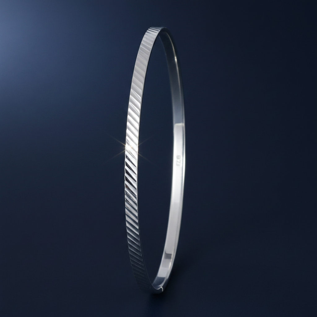 Silver Ladies Round Diamond Cut Bangle on navy blue background