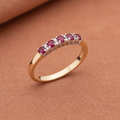 9ct Yellow Gold Ruby & Diamond Eternity Ring 0.56ct on warm terracotta textured background