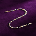 9ct Yellow & White Gold Rhodium Plated 4mm Figaro Chain Bracelet on purple velvet background