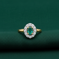 9ct Yellow Gold Emerald Cluster & Diamond Ring 0.45ct on forest green textured background