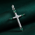 Silver Rhodium Green CZ Cross Pendant on forest green fabric background