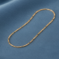 9ct Yellow Gold Figaro Anklet 10" 5.4g on slate blue textured background