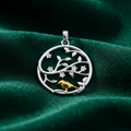 Silver Rhodium Gold Plated Tree of Life Pendant on textured forest green fabric background