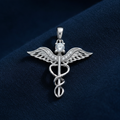 Silver Rhodium Caduceus Pendant on deep navy blue fabric background