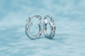 9ct White Gold 13mm Princess Cut CZ Hoop Earrings on icy blue textured background