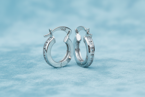 9ct White Gold 13mm Princess Cut CZ Hoop Earrings on icy blue textured background