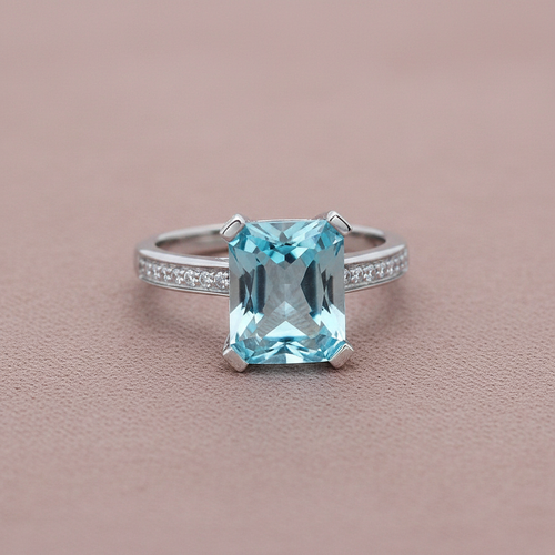 9ct White Gold Blue Topaz & Diamond Ring 4.82ct on dusty rose textured background