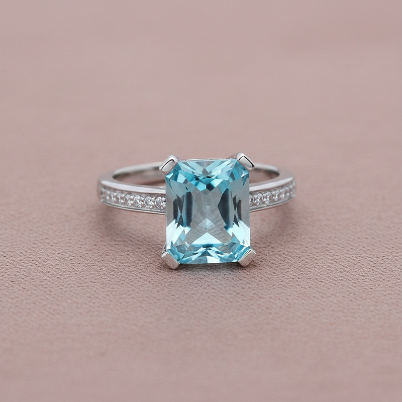 9ct White Gold Blue Topaz & Diamond Ring 4.82ct on dusty rose textured background