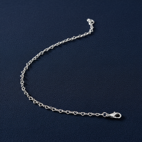 9ct White Gold Heart Shaped Anklet on midnight navy textured background