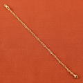 9ct Yellow Gold Hollow Figaro Anklet on burnt orange textured background