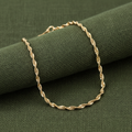 9ct Yellow Gold Hollow Singapore Anklet on olive green textured background