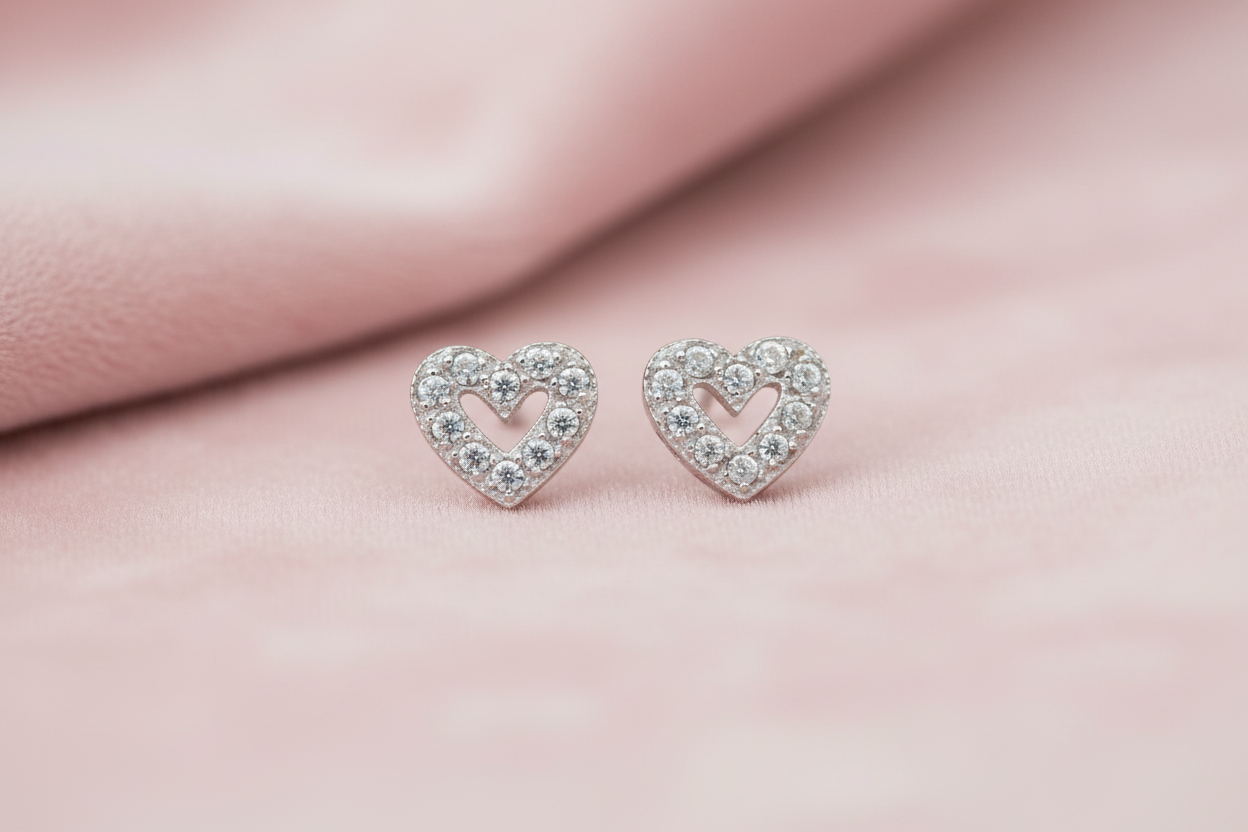 9ct White Gold CZ Heart Stud Earrings on blush pink textured background