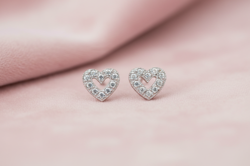 9ct White Gold CZ Heart Stud Earrings on blush pink textured background