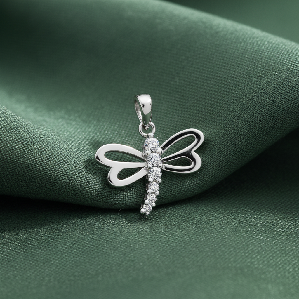 Silver Rhodium CZ Dragonfly Charm Pendant on textured sage green fabric background
