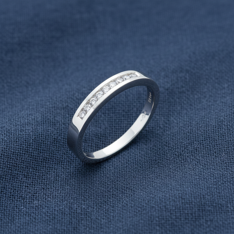 9ct White Gold 0.15ct Diamond Eternity Ring 9 Stone on slate blue textured background