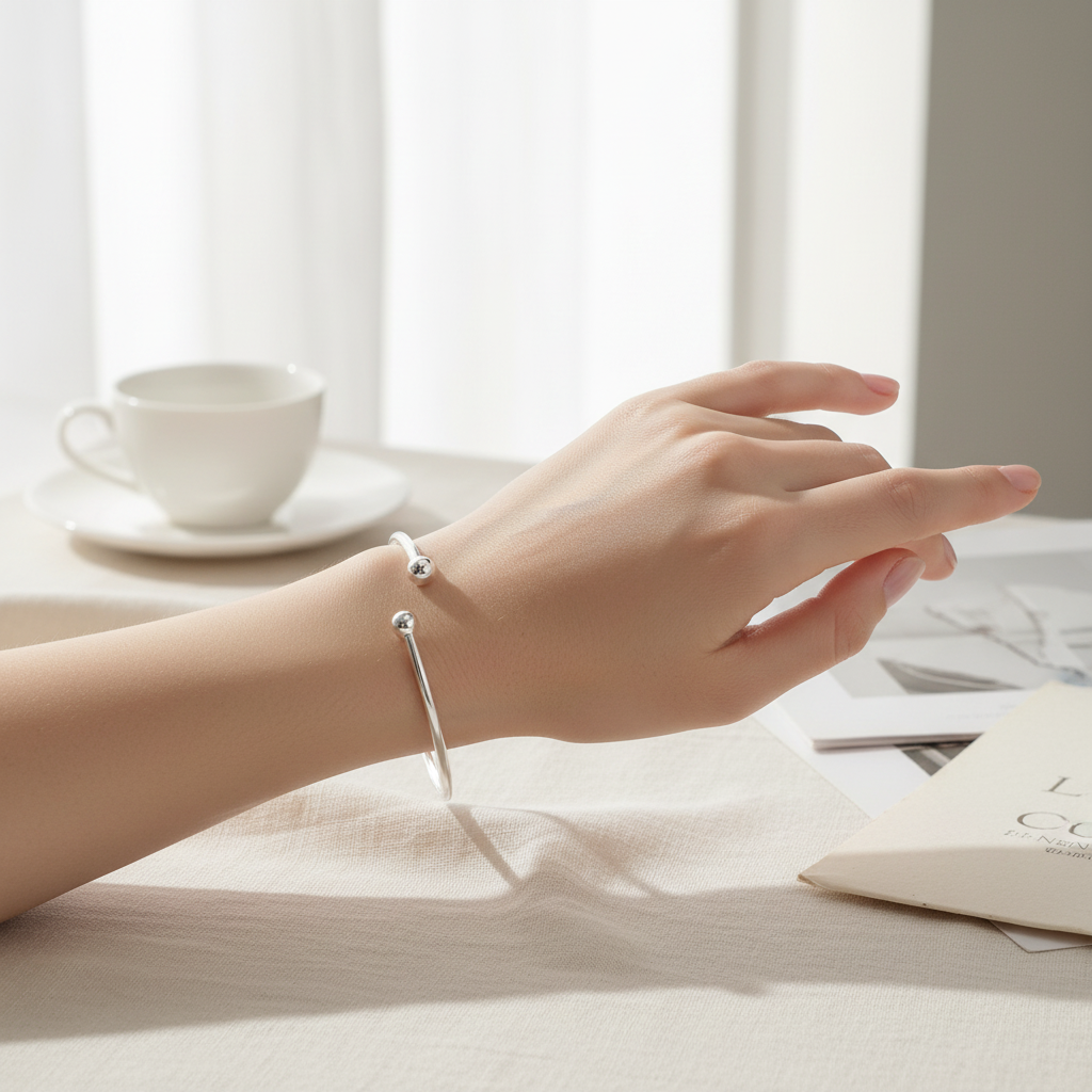 Silver Ladies Torque Bangle worn on a womans wrist