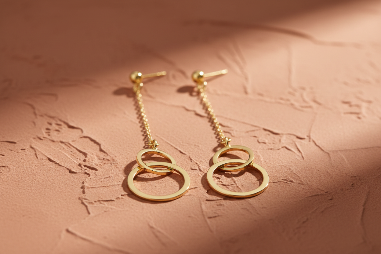 9ct Yellow Gold Circle Drop Earrings on terracotta textured background