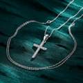 Silver CZ Cross Pendant on textured teal fabric background