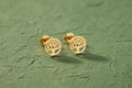9ct Yellow Gold Tree of Life Stud Earrings on forest green textured background
