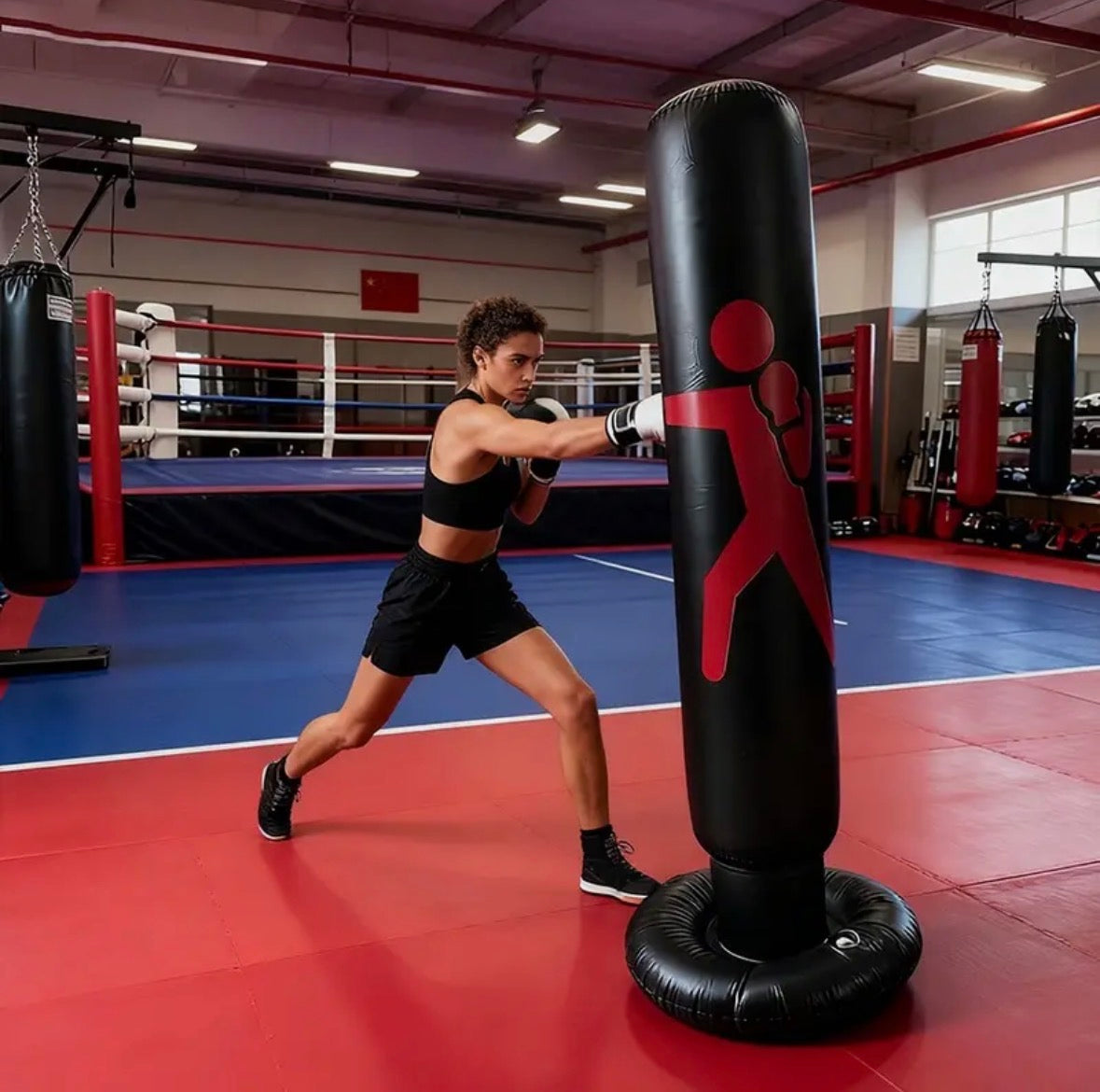 Person training with a punching bag in a boxing ring. By Liff and Co
