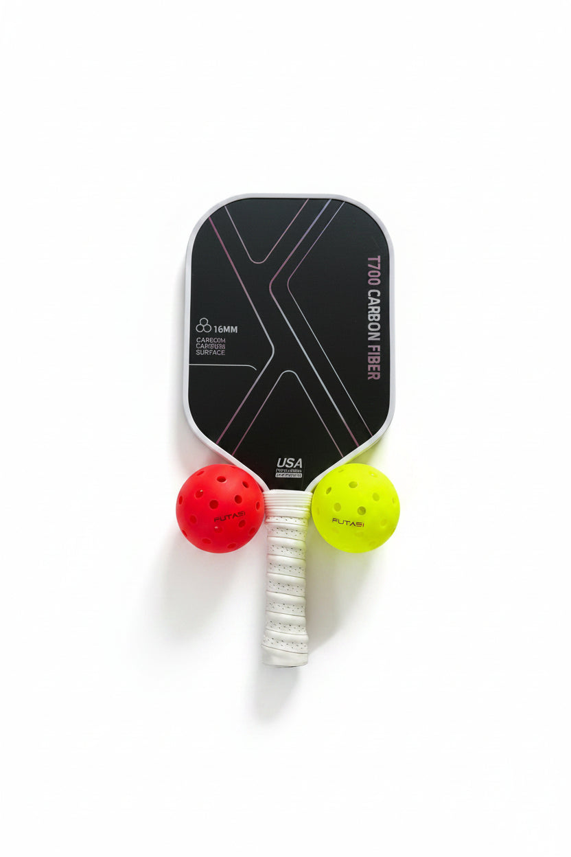 Pickleball paddle with T700 carbon fiber label and two balls on a white surface